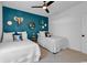 Charming bedroom with a dark accent wall, two twin beds, a ceiling fan, and natural light at 48 Half Shell Ct., Litchfield, SC 29585