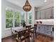 Cozy dining area with ample natural light and stylish chandelier near kitchen at 48 Half Shell Ct., Litchfield, SC 29585