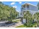 Beautiful two-story home with double garage and balcony, complemented by lush greenery at 48 Half Shell Ct., Litchfield, SC 29585