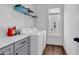 Functional laundry room with modern washer and dryer, overhead storage, and natural light from the window at 48 Half Shell Ct., Litchfield, SC 29585