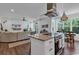 Open-concept living area with an island, stainless steel appliances, and a flat screen television at 48 Half Shell Ct., Litchfield, SC 29585