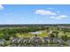 Aerial view of the condo units at 480 River Oaks Dr with a sprawling golf course and nearby highway at 480 River Oaks Dr. # 63-O, Myrtle Beach, SC 29579