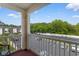 Balcony overlooking parking, landscaping, and surrounding buildings and trees at 480 River Oaks Dr. # 63-O, Myrtle Beach, SC 29579