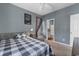 Relaxing bedroom featuring soft lighting, a queen bed, and easy access to bathroom at 480 River Oaks Dr. # 63-O, Myrtle Beach, SC 29579