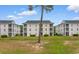 Multi-Gathering units with manicured lawns and landscaping under blue skies at 480 River Oaks Dr. # 63-O, Myrtle Beach, SC 29579