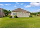 Well-kept backyard with vibrant green grass and neatly arranged shrubbery, enhancing the home's curb appeal at 482 Pomo Dr., Myrtle Beach, SC 29579