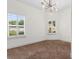 Bright bedroom with large windows dressed with plantation shutters and modern lighting at 482 Pomo Dr., Myrtle Beach, SC 29579