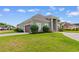 Charming home featuring a well-manicured lawn, complemented by lush shrubs and a neatly paved driveway at 482 Pomo Dr., Myrtle Beach, SC 29579