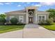 Charming one-story home boasts a classic facade with a large, arched entryway and manicured landscaping at 482 Pomo Dr., Myrtle Beach, SC 29579