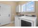 Modern laundry room with appliances, storage cabinet, and bright natural light at 482 Pomo Dr., Myrtle Beach, SC 29579