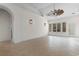 Open living space with elegant archway, neutral tile flooring, and a decorative ceiling fan at 482 Pomo Dr., Myrtle Beach, SC 29579