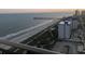 Aerial view featuring a pier and beach along the oceanfront with buildings in the background at 504 N Ocean Blvd. # 1810, Myrtle Beach, SC 29577
