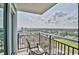 Balcony view featuring the ocean and sandy beach with chairs and a table at 504 N Ocean Blvd. # 1810, Myrtle Beach, SC 29577