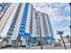 Stunning exterior of a modern high-rise condo building with beautiful blue and white accents and multiple balconies at 504 N Ocean Blvd. # 1810, Myrtle Beach, SC 29577