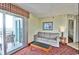 Comfortable living room with a sofa, balcony access, and stylish decor at 504 N Ocean Blvd. # 1810, Myrtle Beach, SC 29577