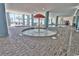 Indoor pool area features an umbrella water feature, hot tub, and ample seating with ocean views at 504 N Ocean Blvd. # 1810, Myrtle Beach, SC 29577