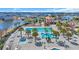 Aerial view of the community pool area with multiple pools, seating, and palm trees surrounded by homes and a lake at 5049 Middleton View Dr., Myrtle Beach, SC 29579