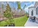 Spacious backyard with a well-maintained lawn, black fence, and a cozy seating area on a concrete patio at 5049 Middleton View Dr., Myrtle Beach, SC 29579