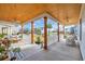 Spacious covered porch features wood columns, ceiling fans, comfortable seating, and a view of the neighborhood at 5049 Middleton View Dr., Myrtle Beach, SC 29579