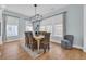 Charming dining room with modern lighting, large windows and seating for six at 5049 Middleton View Dr., Myrtle Beach, SC 29579