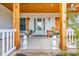 Welcoming front porch with wood accents, a stylish door, pineapple decor, and comfortable seating at 5049 Middleton View Dr., Myrtle Beach, SC 29579