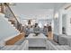 Open-concept living room featuring hardwood floors, a staircase, and views of the kitchen and dining area at 5049 Middleton View Dr., Myrtle Beach, SC 29579