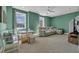 Bright living room featuring light green walls, neutral carpeting, and large windows that offer plenty of natural light at 5049 Middleton View Dr., Myrtle Beach, SC 29579