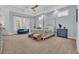 Serene main bedroom with a four-poster bed, ample natural light, and tray ceilings at 5049 Middleton View Dr., Myrtle Beach, SC 29579