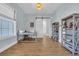 Bright and airy office space features a desk, shelves, and a sliding barn door for added privacy at 5049 Middleton View Dr., Myrtle Beach, SC 29579