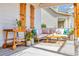 Cozy porch setting with wicker furniture, stylish decor, and potted plants, perfect for outdoor relaxation at 5049 Middleton View Dr., Myrtle Beach, SC 29579