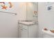 Compact bathroom featuring a single vanity, framed mirror, and decorative starfish accents at 509 Wildfire Ct., Longs, SC 29568