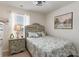 Cozy bedroom with a decorative headboard, neutral walls and a coordinated nightstand and lamp at 509 Wildfire Ct., Longs, SC 29568