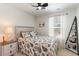 Bright bedroom featuring a ceiling fan, shelving unit, and coastal themed bedding at 509 Wildfire Ct., Longs, SC 29568