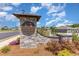 Stone community entrance sign for 'The Forest At Black Bear' with landscaping and clear blue skies at 509 Wildfire Ct., Longs, SC 29568
