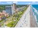 Aerial view of condo building complex near the beach, showing the landscape and parking at 5511 N Ocean Blvd. # 209, Myrtle Beach, SC 29577