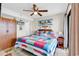 Cozy bedroom with colorful quilt, beach decor, and a ceiling fan providing a relaxing ambiance at 5511 N Ocean Blvd. # 209, Myrtle Beach, SC 29577