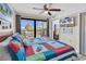 Comfortable bedroom featuring a balcony with stunning views and a wall-mounted television at 5511 N Ocean Blvd. # 209, Myrtle Beach, SC 29577