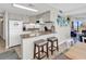 Bright and open kitchen with bar seating and views of the living area and ocean at 5511 N Ocean Blvd. # 209, Myrtle Beach, SC 29577