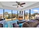 Living room with floor-to-ceiling windows showcasing beautiful views of the ocean and palm trees at 5511 N Ocean Blvd. # 209, Myrtle Beach, SC 29577