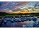 A picturesque sunset over a serene marina filled with boats creates a tranquil ambiance at 5511 N Ocean Blvd. # 209, Myrtle Beach, SC 29577