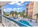 Balcony view of a community pool surrounded by palm trees with an ocean view at 5511 N Ocean Blvd. # 209, Myrtle Beach, SC 29577