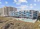 Aerial view showcasing a beachfront condo building with a pool and direct beach access at 5600 Ocean Blvd. N # A11, North Myrtle Beach, SC 29582