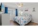Nautical-themed bedroom with a comfortable bed, ceiling fan, and natural light at 5600 Ocean Blvd. N # A11, North Myrtle Beach, SC 29582
