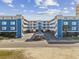 Attractive condo complex with blue siding, white balconies, and ample parking, creating a welcoming coastal residence at 5600 Ocean Blvd. N # A11, North Myrtle Beach, SC 29582