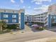 Inviting condo complex featuring blue siding, multiple balconies, and well-maintained landscaping, offering a charming coastal appeal at 5600 Ocean Blvd. N # A11, North Myrtle Beach, SC 29582