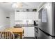 Bright kitchen with white cabinetry, stainless steel appliances, and a ceiling fan at 5600 Ocean Blvd. N # A11, North Myrtle Beach, SC 29582