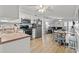 Open-concept kitchen and dining area with stainless steel appliances and laminate floors at 5600 Ocean Blvd. N # A11, North Myrtle Beach, SC 29582