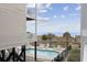 Inviting community pool and hot tub with lounge chairs, surrounded by a black metal fence near the beach at 5600 Ocean Blvd. N # A11, North Myrtle Beach, SC 29582