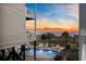 Relaxing pool area with lounge chairs, complemented by ocean views and a beautiful sunset backdrop at 5600 Ocean Blvd. N # A11, North Myrtle Beach, SC 29582