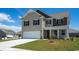 Two-story home with a two-car garage and neat landscaping, set on a green lawn under a clear blue sky at 6027 Forest Dell Ct, Myrtle Beach, SC 29579